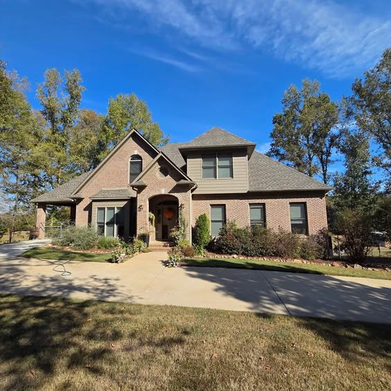 Brick home exterior with completed roof and front entry work