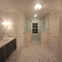 Bathroom renovation with two vanities and patterned tile floor