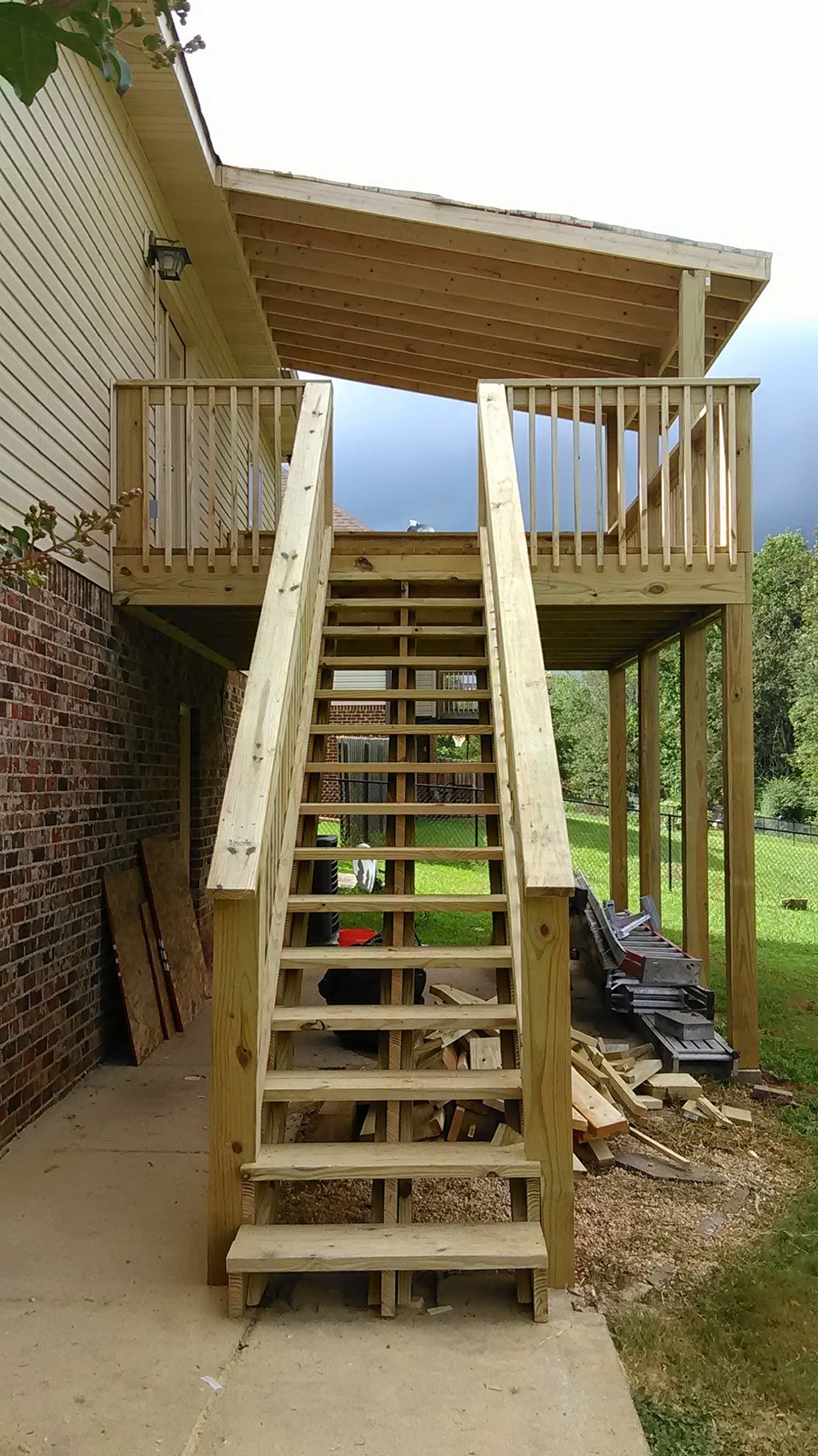 New exterior wood stairs leading to an elevated deck