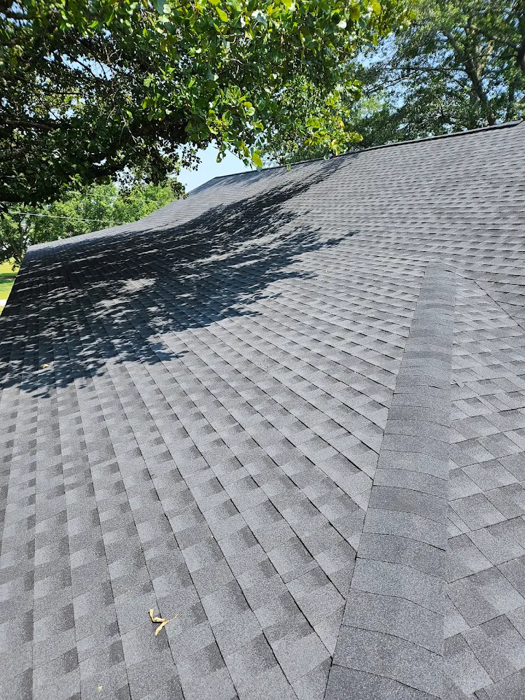 Gray asphalt shingles across intersecting roof slopes